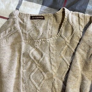 Sweater with lace on bottom.